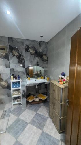a bathroom with a sink and a mirror on the wall at Petite villa benkrara فيلا صغيرة بن كرارة in Iterkine