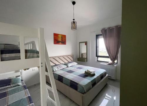 a bedroom with a bunk bed and two bunk beds at Relax apartment, Side Sea View, Golem, Albania in Golem