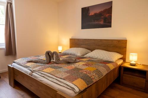 a bedroom with a bed with a quilt on it at Villa Boca in Nižná Boca