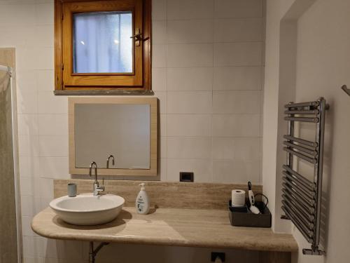 a bathroom with a sink and a mirror at Casabella Mondello in Mondello