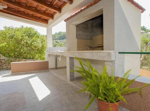 a patio with a large outdoor kitchen in a house at House B - 45m from the Sea in Vela Luka