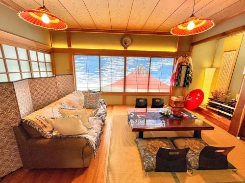 a living room with a couch and a table at Japanese Style Hotel WAKUWAKU-BASE Nakasendo Yabuharajuku