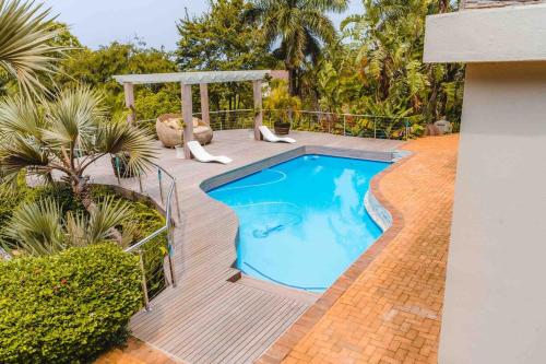 a small swimming pool on a wooden deck at Poolside Flat Southbroom in Southbroom