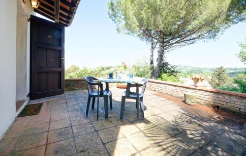 a table and chairs on a patio with a view at Pet Friendly Home In Montechiari in Forcoli