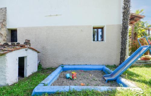 a playground with a slide in a yard at Pet Friendly Home In Montechiari in Forcoli
