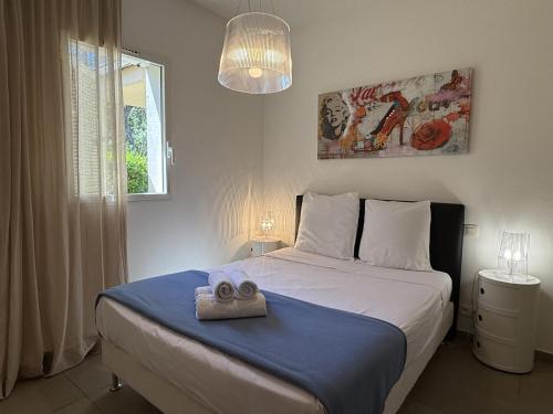 a bedroom with a bed with a towel on it at T4 Cote Plage N6 face a la mer in Pinarellu