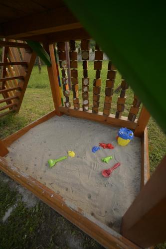 a sandbox with toys in the sand in a crib at Vila Fruškica in Vrdnik