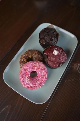 three donuts on a white plate on a table at Vila Fruškica in Vrdnik