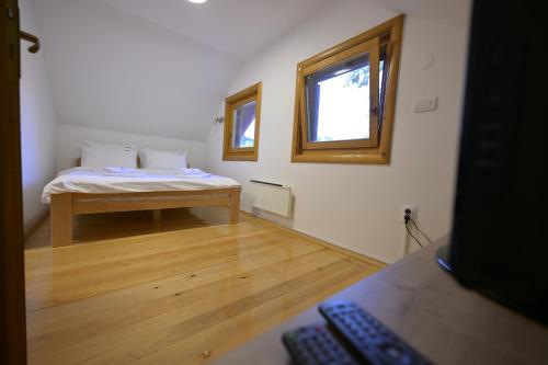 a room with a bed and a window in it at Vila Fruškica in Vrdnik