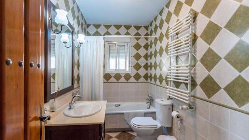 a bathroom with a sink and a toilet and a tub at Casa La Lomilla Canillas de Albaida by Ruralidays in Árchez