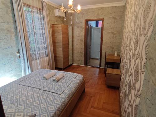 a bedroom with a bed with two towels on it at Guesthouse Mery in K'obulet'i