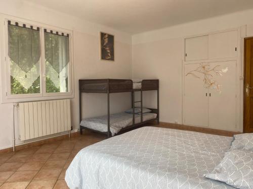 une chambre avec deux lits superposés et une fenêtre dans l'établissement Maison 8 couchages avec piscine, à Forcalquier