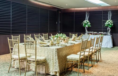 a table set up for a wedding with chairs at Sonesta Hotel Cali in Cali