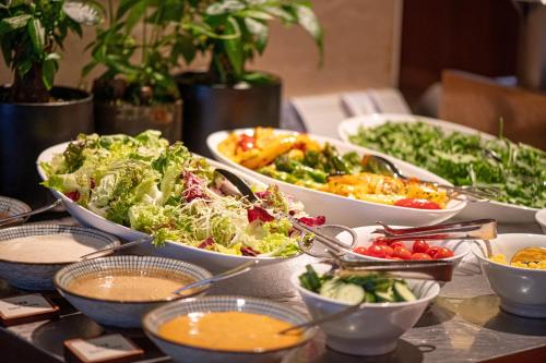 a table topped with bowls of different types of food at Grand Hyatt Shenzhen in Shenzhen