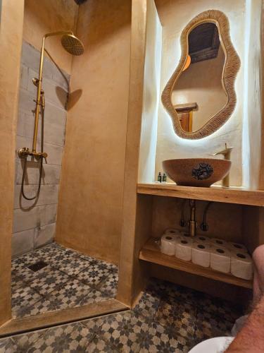 a bathroom with a sink and a shower at BROWN ON GREEN a stone house with amazing view in Drapaniás