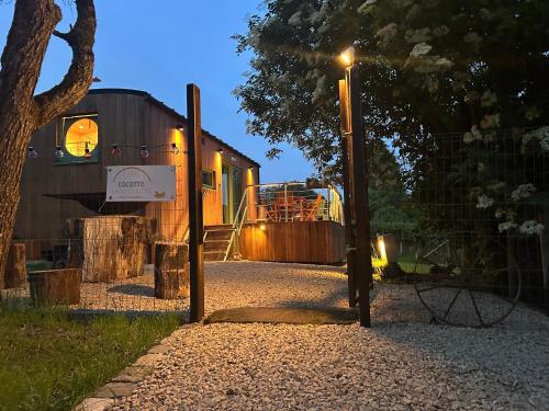 a house with a street light in front of it at GITE Cocotte La Roulotte in Fauvillers