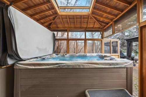 a hot tub in a house with a roof at The Royal Ravine Luxury Retreat with Hot Tub & Sauna in Calgary
