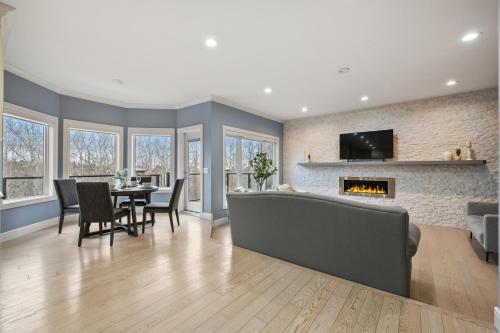 a living room with a couch and a fireplace at The Royal Ravine Luxury Retreat with Hot Tub & Sauna in Calgary