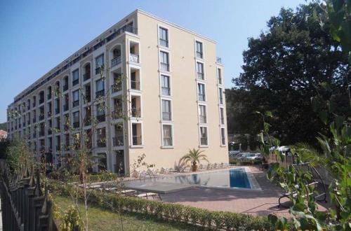 a large white building with a pool in front of it at Квартира студия Villa Astoria 2 Болгария Солнечный берег in Elenite