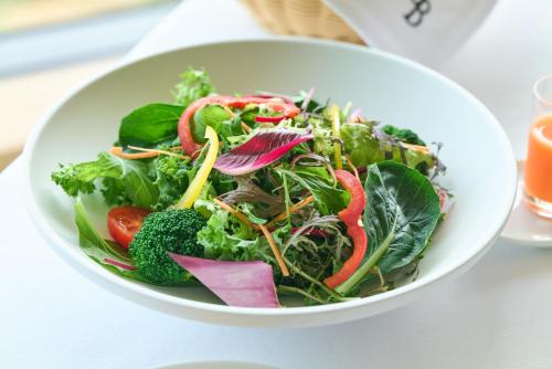 a salad in a white bowl on a table at Hotel Grand Bach Atami Crescendo in Atami