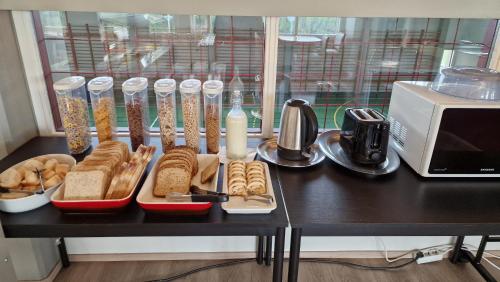 a black table with bread and other food on it at Hunavellir Guesthouse in Blönduós