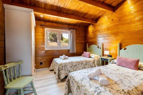 a bedroom with two beds and a window at Cortijo la Jimena 2 in Benablón