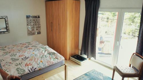 a bedroom with a bed and a sliding glass door at Haus Hönigblick in Wilnsdorf