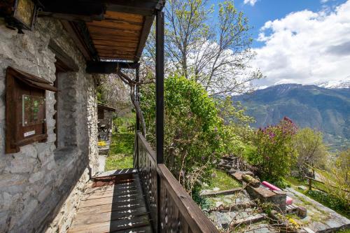 a stairway leading to a house with mountains in the background at Agriturismo Les Ecureuils in Saint-Pierre