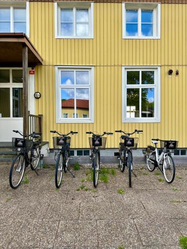 a row of bikes parked in front of a yellow building at Ljungskile Hotell & Konferens in Ljungskile