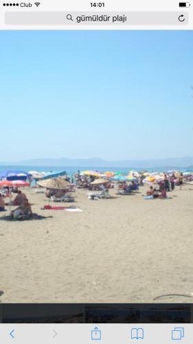 a picture of a beach with people on it at Hotel Efes in Gumuldur