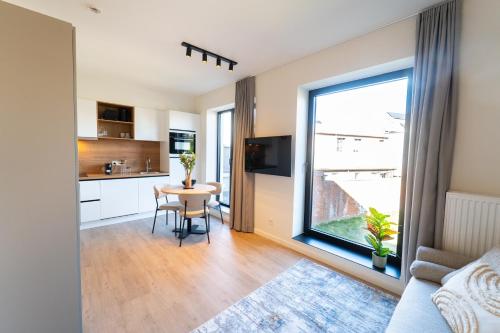 a kitchen and dining room with a table and a window at Fourstay Luxury City Apartments Diegem - Brussels in Diegem