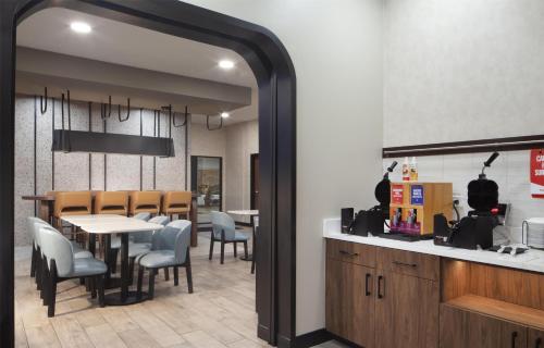 a dining room with a table and chairs at Hampton Inn by Hilton Tampa Fairgrounds Casino in Tampa