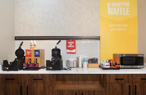 a counter in a store with a microwave and a counter sidx sidx at Hampton Inn by Hilton Tampa Fairgrounds Casino in Tampa
