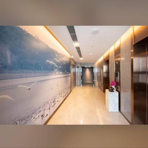 a hallway with birds on the wall in a building at Atour Hotel Shenzhen Fuhai International Convention and Exhibition Center in Bao'an