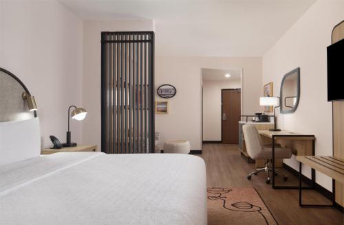 a hotel room with a bed and a desk at Hampton Inn by Hilton Tampa Fairgrounds Casino in Tampa