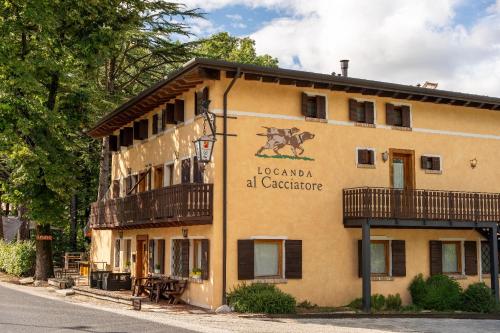 a building with a sign on the side of it at Locanda Al Cacciatore in Nervesa della Battaglia
