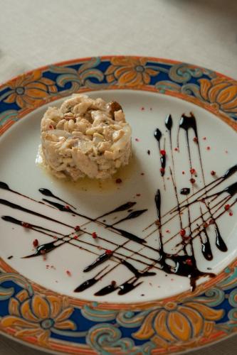 a plate with a piece of cake and chocolate sauce at Locanda Al Cacciatore in Nervesa della Battaglia
