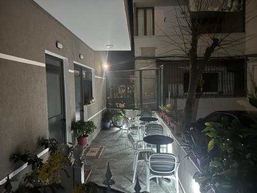 a row of tables and chairs on a balcony at Lola's Rooms in Gjirokastër