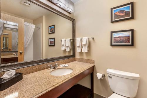 a bathroom with a sink and a toilet and a mirror at Comfort Inn & Suites Durango in Durango