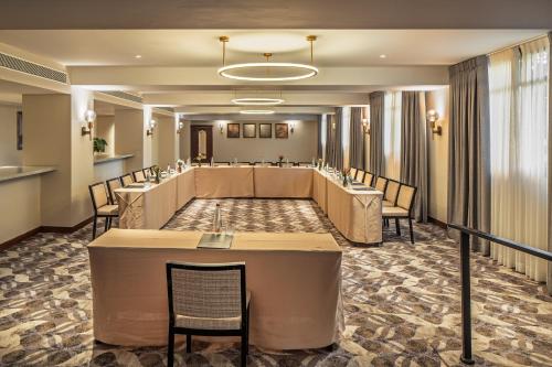 a large waiting room with a long table and chairs at Mizpe Hayamim by Isrotel Exclusive in Rosh Pinna