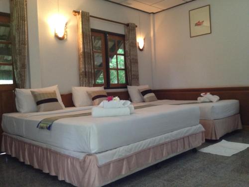 Ένα ή περισσότερα κρεβάτια σε δωμάτιο στο Clearwave resort Chumphon คลีนเวฟ รีสอร์ท