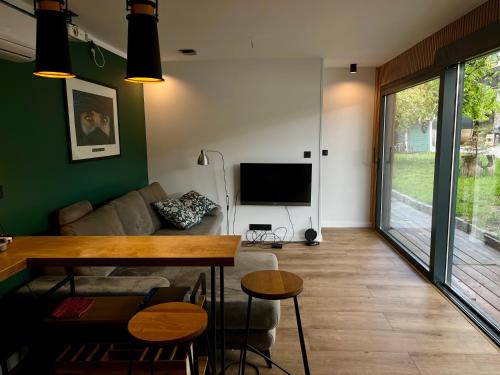 a living room with a couch and a television at Touareg House in Szczyrk