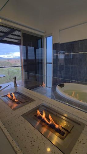 a fireplace in a bathroom with a tub and a fire place at Barossa Pavilions & Glasshouse in Lyndoch
