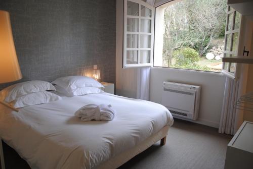 En eller flere senge i et værelse på Villa 12 couchages avec piscine