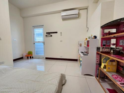 a white room with a refrigerator and a door at 谷香 Guxiang House 東區靜巷透天獨棟 in Tainan