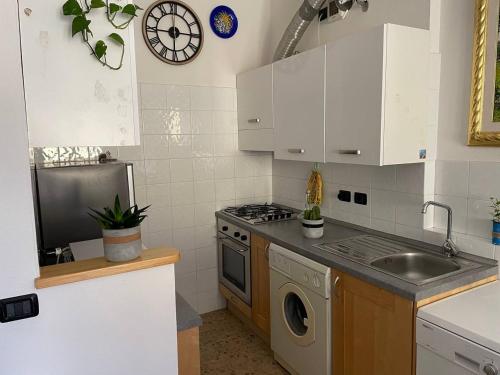 a kitchen with a sink and a stove top oven at La Casetta in Calizzano