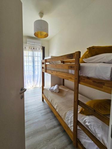 two bunk beds in a room with a window at Villa Versilia in Lido di Camaiore