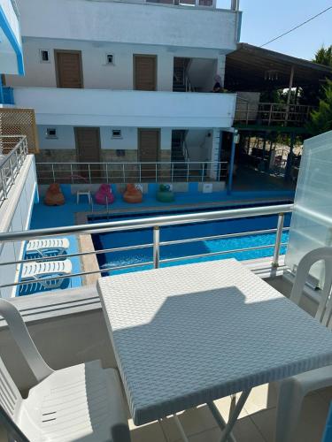 a balcony with a table and chairs next to a swimming pool at Casa Luma Avşa Island in Avşa Adası