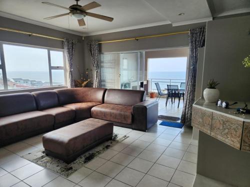 a living room with a brown couch and a table at 13 on Collison in Margate