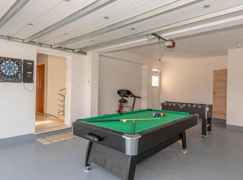 a room with a pool table in a room at Villa Maria with Outdoor Pool in Drniš